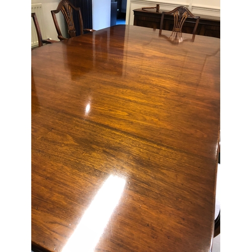 208 - A large extending mahogany board room table with 8 carver chairs
This lot remains located in a offic... 