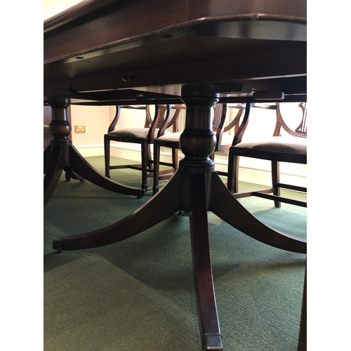 208 - A large extending mahogany board room table with 8 carver chairs
This lot remains located in a offic... 