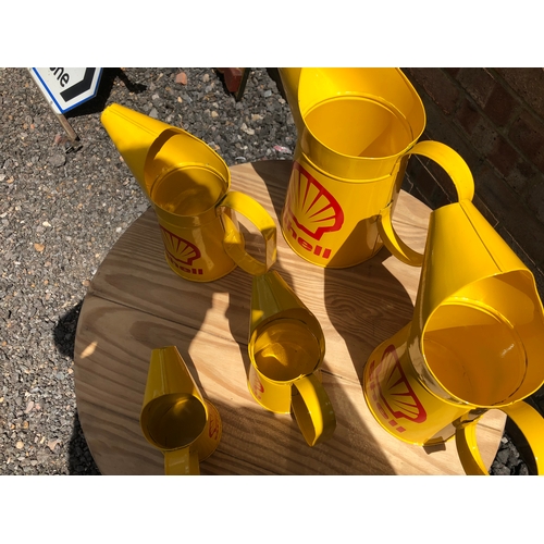 269 - A set of five shell oils pouring cans