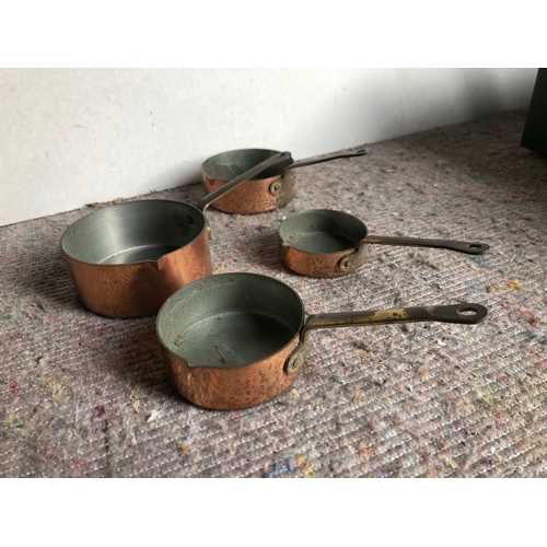 473 - Copper spirit pan, together with a set of miniature pans