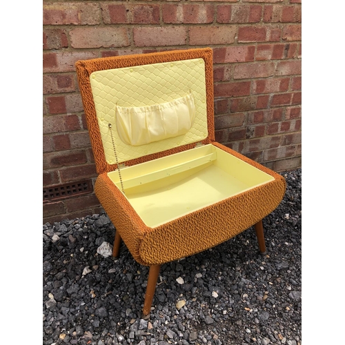 107 - A 1970's orange upholstered sewing box / ottoman