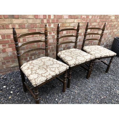 120 - Three oak ladder back chairs by Younger