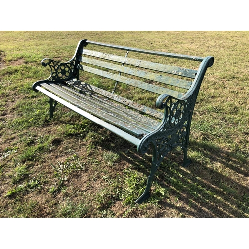 18 - A green painted garden bench, cast iron frame with slatted wooden seat