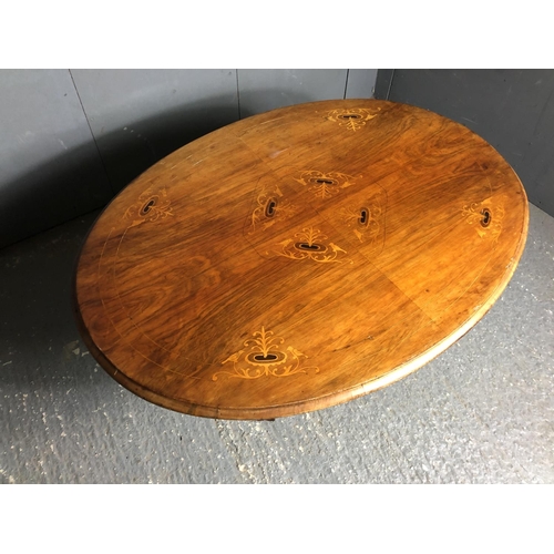 32 - A low Victorian tip up table with inlaid top