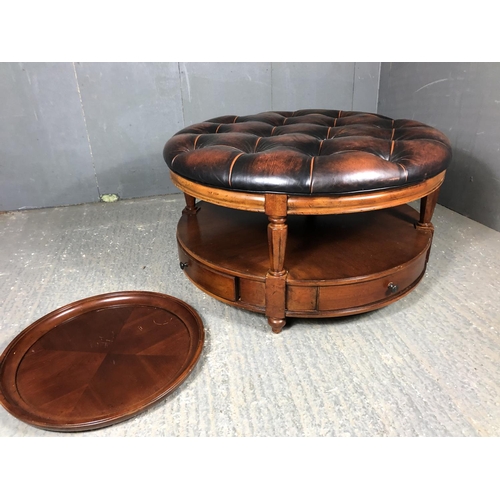 39 - A brown leather Chesterfield centre table / ottoman housing two drawers, together with matching drin... 