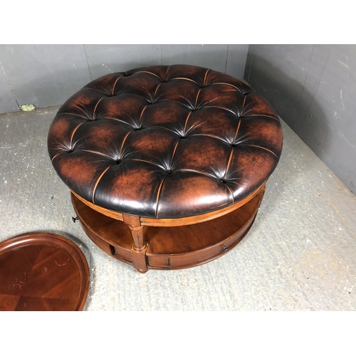 39 - A brown leather Chesterfield centre table / ottoman housing two drawers, together with matching drin... 