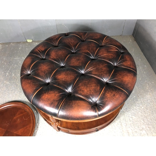 39 - A brown leather Chesterfield centre table / ottoman housing two drawers, together with matching drin... 