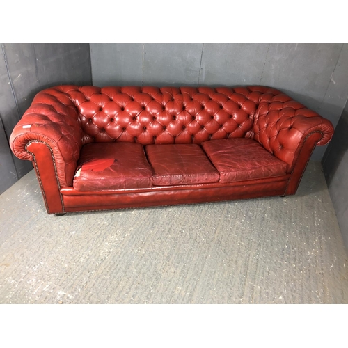 40 - A red leather three seat Chesterfield sofa by Pegasus