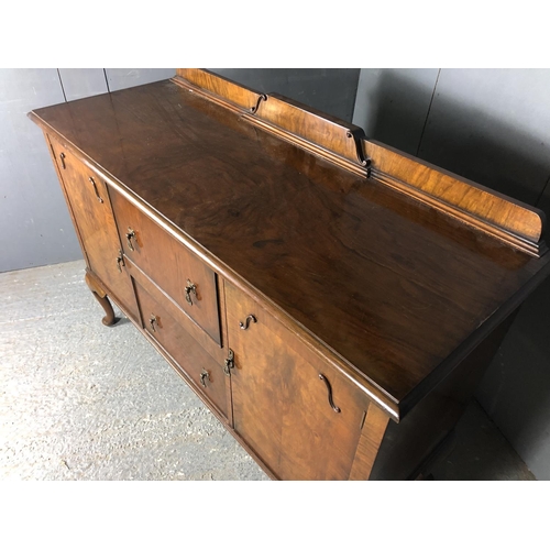 42 - A walnut queen anne style sideboard, two cupboards and two doors