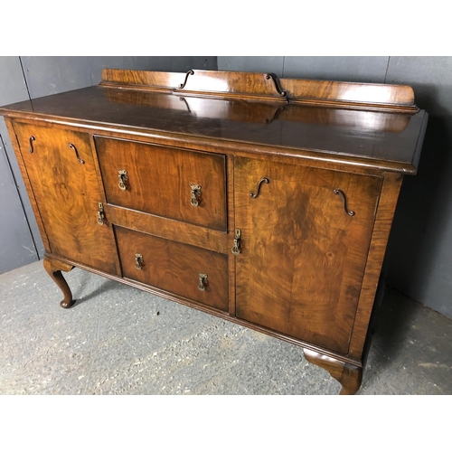 42 - A walnut queen anne style sideboard, two cupboards and two doors