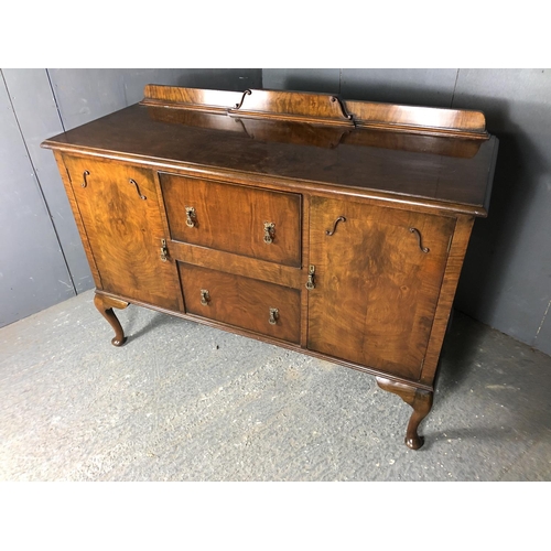 42 - A walnut queen anne style sideboard, two cupboards and two doors