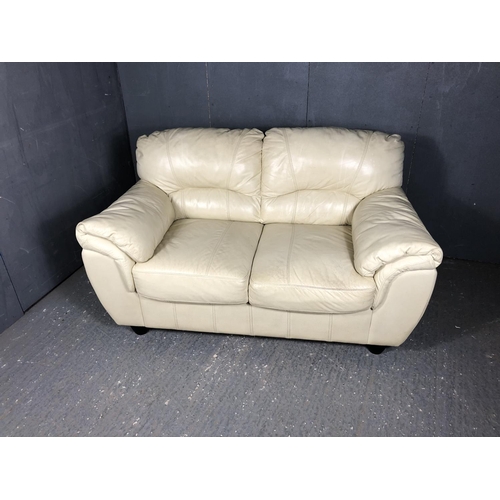 44 - A modern cream leather two seater sofa