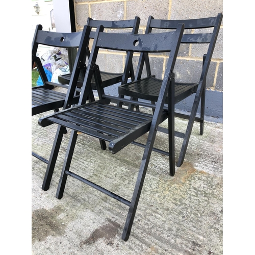 101 - A set of four black folding chairs