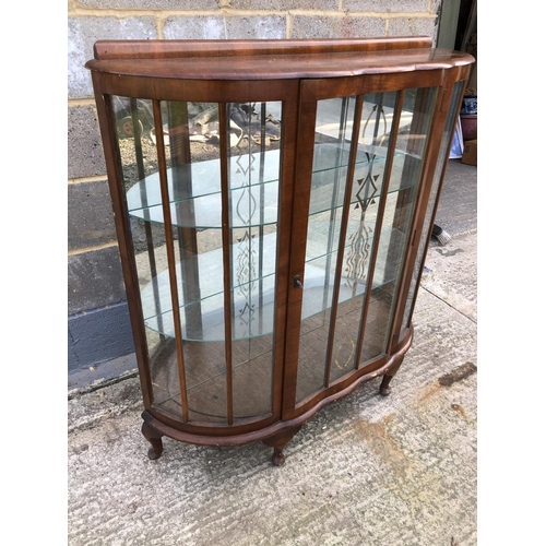 111 - A 1930's walnut china display cabinet with glass shelves and mirror back 106 wide