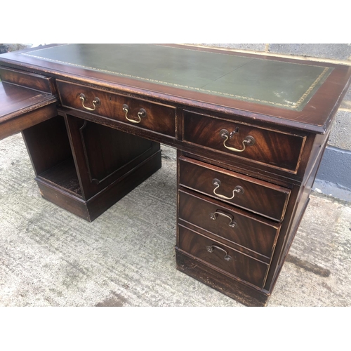 118 - A reproduction mahogany corner desk with green leather top  (AF)