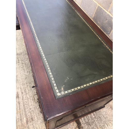 118 - A reproduction mahogany corner desk with green leather top  (AF)