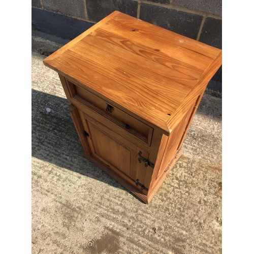 128 - A pine bedside with single drawer over cupboard