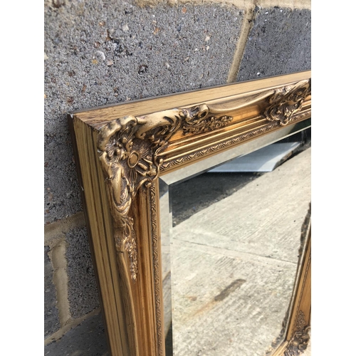 129 - A Large gold gilt overmantle mirror 67x92