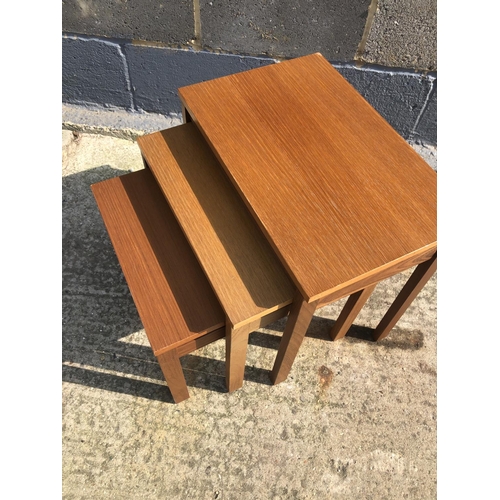 135 - A teak nest of three occasional tables