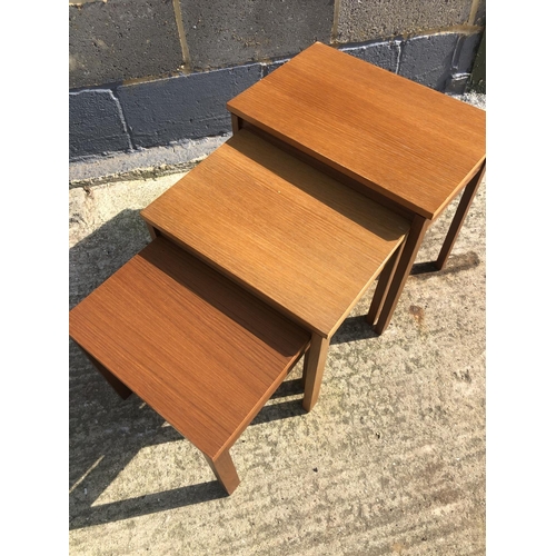 135 - A teak nest of three occasional tables