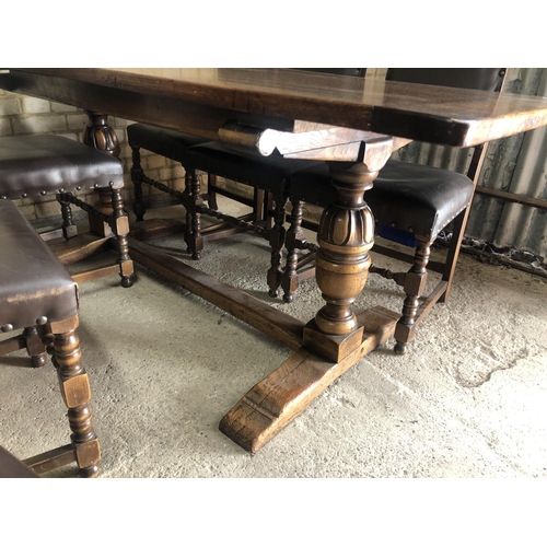 151 - An oak refectory dining table together with a set of six studded brown leather chairs by Jaycee