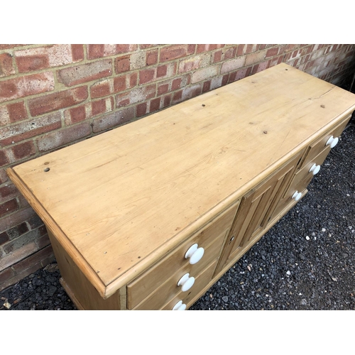 16 - Country pine sideboard, housing six drawers and a single cupboard door 154x49x80