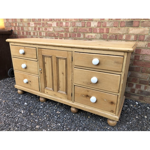 16 - Country pine sideboard, housing six drawers and a single cupboard door 154x49x80