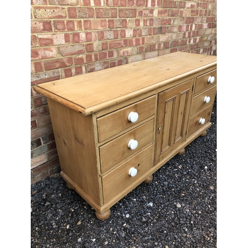 16 - Country pine sideboard, housing six drawers and a single cupboard door 154x49x80