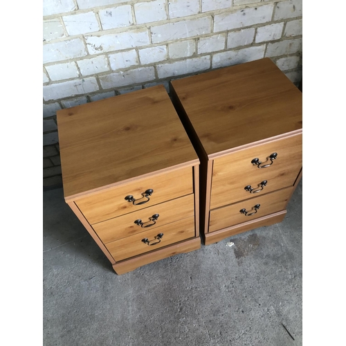 160 - A pair of modern pine effect bedside chests of three