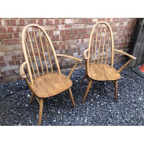 180 - A pair of blonde Elm Ercol carver chairs