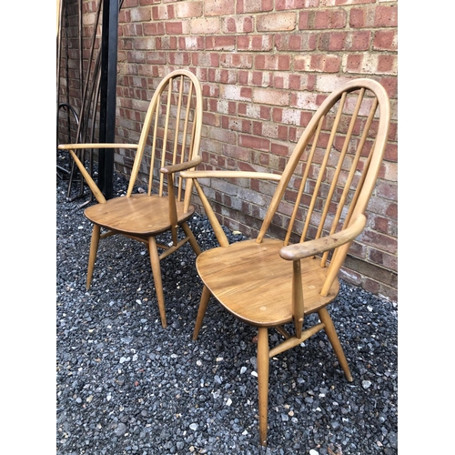 180 - A pair of blonde Elm Ercol carver chairs