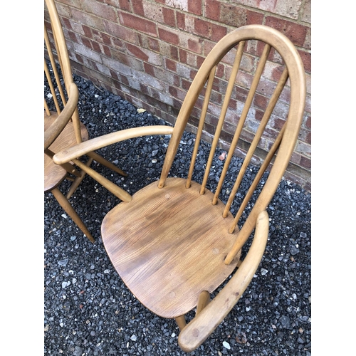 180 - A pair of blonde Elm Ercol carver chairs