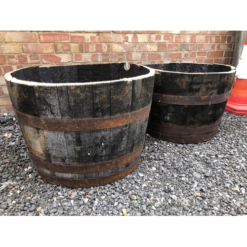 194 - A pair of half whiskey barrel planters