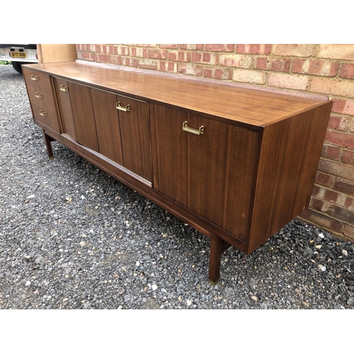 200 - A teak sideboard by g Plan with concertina doors and drinks cabinet section 221cm wide