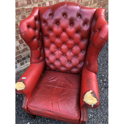 209 - A red leather Chesterfield wing chair (AF)