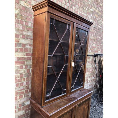 22 - An Edwardian mahogany bookcase cupboard with satinwood inlay 107x48x220