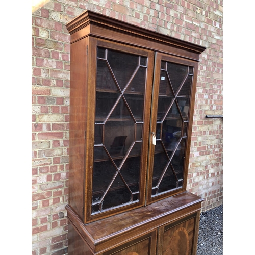 22 - An Edwardian mahogany bookcase cupboard with satinwood inlay 107x48x220