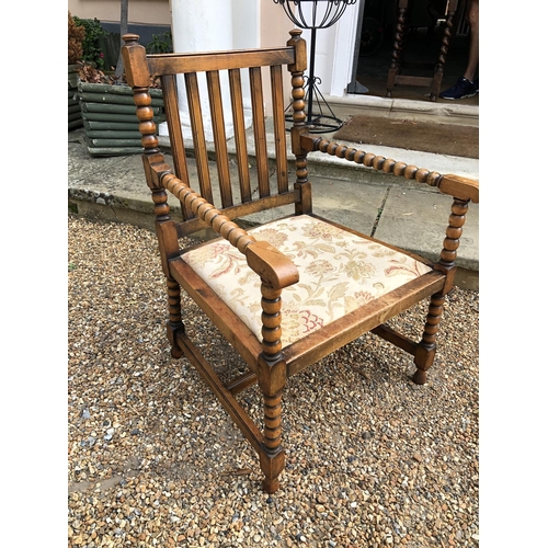 222 - A oak bobbin armchair with upholstered seat