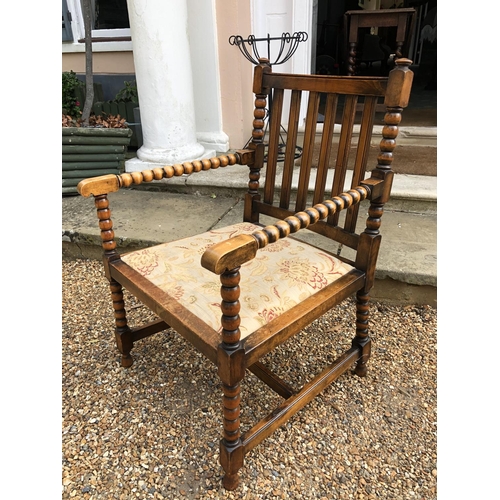 222 - A oak bobbin armchair with upholstered seat