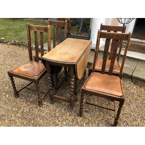 223 - A set of four 1920's oak dining chairs together with a barley twist gateleg table