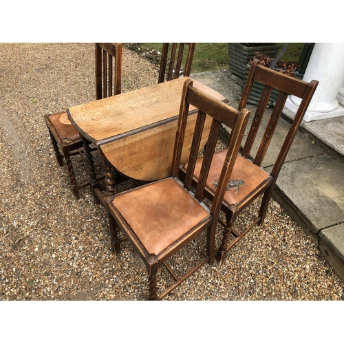 223 - A set of four 1920's oak dining chairs together with a barley twist gateleg table