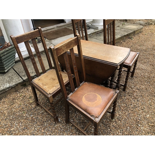 223 - A set of four 1920's oak dining chairs together with a barley twist gateleg table