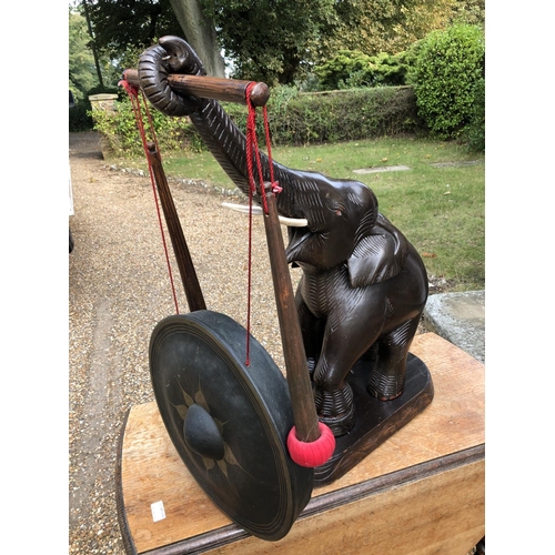 224 - A carved wooden elephant gong with beater 75cm high