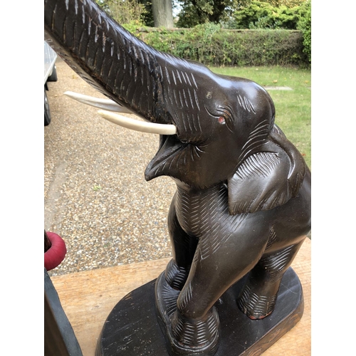 224 - A carved wooden elephant gong with beater 75cm high