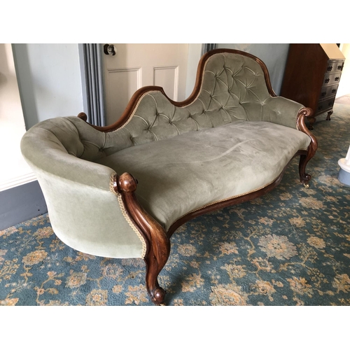 225 - A mahogany framed Victorian chaise lounge in green upholstery