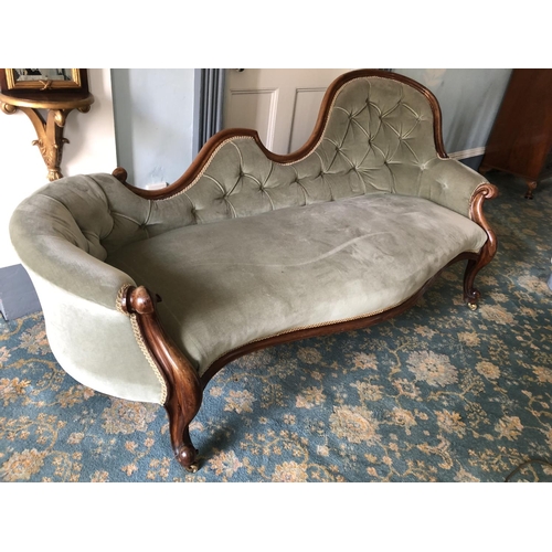 225 - A mahogany framed Victorian chaise lounge in green upholstery