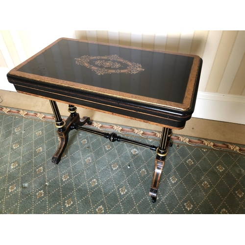 228 - A Victorian ebonised Card table with walnut inlaid sections, twisting and unfolding to reveal a blue... 