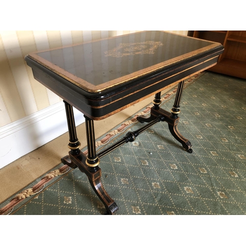 228 - A Victorian ebonised Card table with walnut inlaid sections, twisting and unfolding to reveal a blue... 