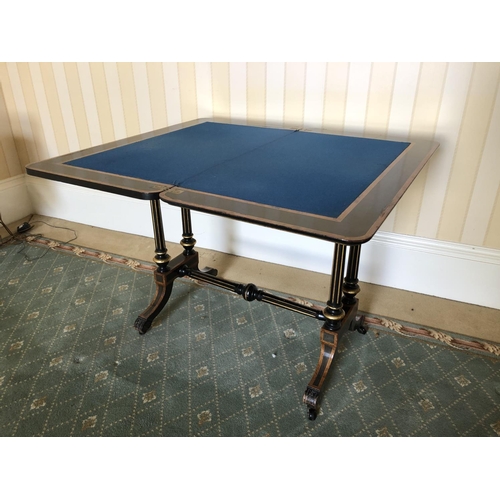 228 - A Victorian ebonised Card table with walnut inlaid sections, twisting and unfolding to reveal a blue... 