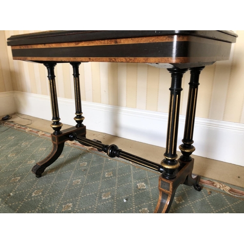 228 - A Victorian ebonised Card table with walnut inlaid sections, twisting and unfolding to reveal a blue... 